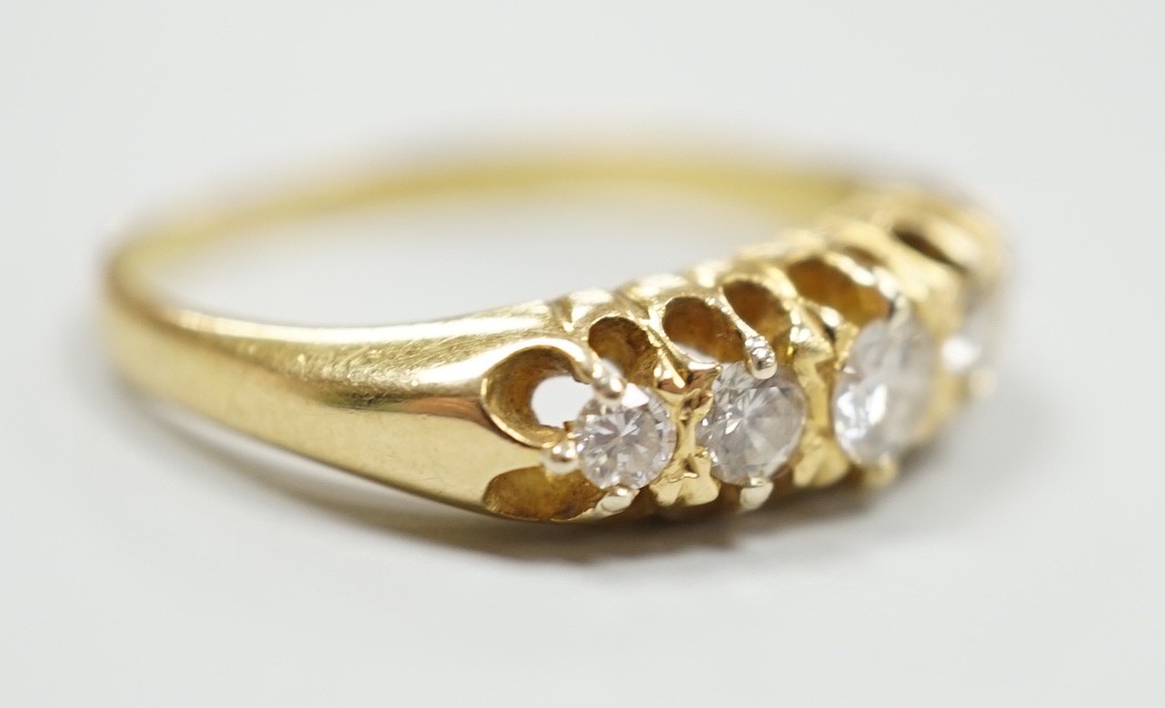 An early 20th century gold and graduated five stone diamond set half hoop ring, size O/P, gross weight 4.3 grams.